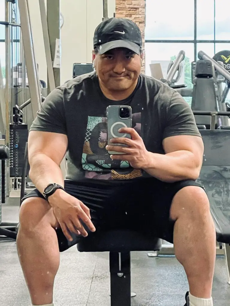 A personal trainer in a dark gym, ready to guide you through strength training